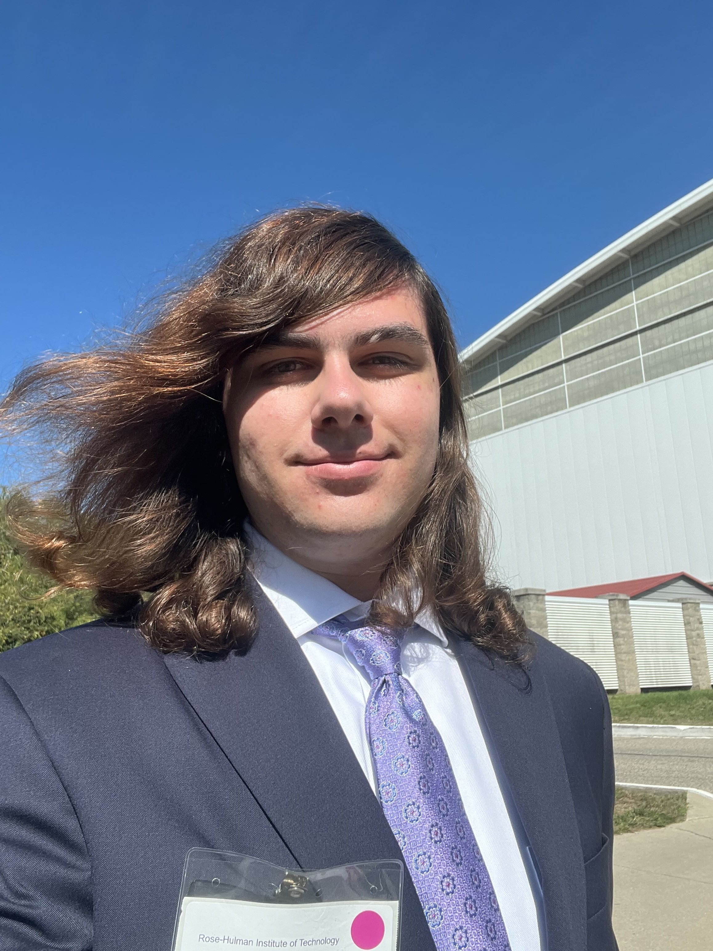 Me sanding outside with a suit on.